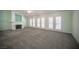 Spacious living room featuring a fireplace, multiple sets of French doors, and neutral carpeting at 9728 Drumcannon Ave, Las Vegas, NV 89129