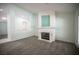 Cozy living room with a fireplace, plush gray carpeting, and an open layout at 9728 Drumcannon Ave, Las Vegas, NV 89129