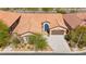 Aerial view of home showcasing desert landscaping, tile roof, and an oversized driveway and garage at 10348 Hawks Wing St, Las Vegas, NV 89178
