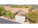 Aerial view of a well-maintained home with desert landscaping and a spacious multi-car driveway at 10348 Hawks Wing St, Las Vegas, NV 89178
