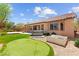 Spacious backyard with putting green, hot tub, and desert landscaping, perfect for outdoor enjoyment at 10348 Hawks Wing St, Las Vegas, NV 89178