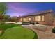 Lush backyard with a putting green, patio, and relaxing hot tub at 10348 Hawks Wing St, Las Vegas, NV 89178