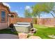 Backyard featuring a hot tub, putting green, and mature landscaping at 10348 Hawks Wing St, Las Vegas, NV 89178