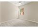 Well-lit bedroom with soft carpet, ceiling fan, and a sunlit window at 10348 Hawks Wing St, Las Vegas, NV 89178
