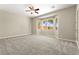 Spacious bedroom with bay window providing natural light and ceiling fan at 10348 Hawks Wing St, Las Vegas, NV 89178