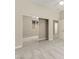Bright bedroom featuring a mirrored closet, gray carpet, and natural light from a window at 10348 Hawks Wing St, Las Vegas, NV 89178