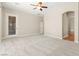 Large bedroom featuring a doorway, ceiling fan, and plush carpeting at 10348 Hawks Wing St, Las Vegas, NV 89178