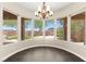 Elegant dining area with chandelier and many windows offering natural light and tree views at 10348 Hawks Wing St, Las Vegas, NV 89178