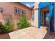 Inviting courtyard entrance featuring a decorative gate and lush greenery at 10348 Hawks Wing St, Las Vegas, NV 89178