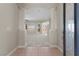 Elegant foyer with tile flooring, grand columns, and an open view into the living area at 10348 Hawks Wing St, Las Vegas, NV 89178
