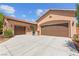 Spacious three-car garage with brown doors offering ample parking and storage space at 10348 Hawks Wing St, Las Vegas, NV 89178