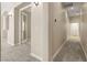 Neutral hallway with soft carpet leads to various rooms of the residence at 10348 Hawks Wing St, Las Vegas, NV 89178