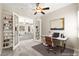 Home office with built-in shelves and view to living room at 10348 Hawks Wing St, Las Vegas, NV 89178