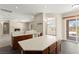 Bright kitchen with island opens to a dining and living area, showcasing an open-concept living space at 10348 Hawks Wing St, Las Vegas, NV 89178