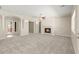 Spacious living room features plush carpeting, a fireplace, and multiple entryways for easy flow at 10348 Hawks Wing St, Las Vegas, NV 89178