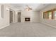 Expansive living room with fireplace, plush carpet, and neutral tones creating a relaxing atmosphere at 10348 Hawks Wing St, Las Vegas, NV 89178