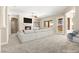 Bright, open living room with plush carpet, a cozy fireplace, and ample natural light at 10348 Hawks Wing St, Las Vegas, NV 89178