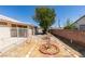 Desert landscaped backyard features mature tree, decorative brick accents, and patio area at 1110 Orchard Valley Dr, Las Vegas, NV 89142