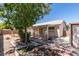 Backyard features a mature tree, desert landscaping, brick accents, and storage shed at 1110 Orchard Valley Dr, Las Vegas, NV 89142