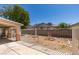 Backyard features mature tree, white metal fence, desert landscaping, and covered patio at 1110 Orchard Valley Dr, Las Vegas, NV 89142