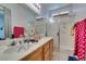 Bathroom features a dual sink vanity with a walk-in shower and bright natural light at 1110 Orchard Valley Dr, Las Vegas, NV 89142
