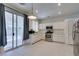 Bright kitchen features stainless steel appliances, white cabinets, and sliding glass door to the patio at 1110 Orchard Valley Dr, Las Vegas, NV 89142