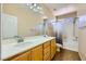Bathroom featuring a dual sink vanity, a large mirror, and a shower-tub combination with a curtain at 1178 Yellow Orchid St, Henderson, NV 89002