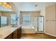 Bright bathroom featuring a large soaking tub and separate shower, complemented by a double vanity and neutral tones at 1178 Yellow Orchid St, Henderson, NV 89002