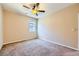 This bedroom offers ample natural light from the window, a ceiling fan, and neutral carpeting at 1178 Yellow Orchid St, Henderson, NV 89002