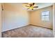 Carpeted bedroom featuring a ceiling fan, natural light and neutral walls at 1178 Yellow Orchid St, Henderson, NV 89002
