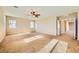 Large bedroom with carpet, a ceiling fan, and a side hallway at 1178 Yellow Orchid St, Henderson, NV 89002
