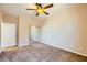 Carpeted bedroom featuring a ceiling fan and mirrored sliding doors at 1178 Yellow Orchid St, Henderson, NV 89002