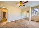 Carpeted bedroom with a ceiling fan and a large sliding closet at 1178 Yellow Orchid St, Henderson, NV 89002