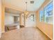 Elegant dining room showcasing ample natural light through large windows, neutral tones, and stylish chandelier at 1178 Yellow Orchid St, Henderson, NV 89002