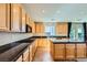 Modern kitchen with granite counters, stainless steel appliances, and tile floors offers style and functionality at 1178 Yellow Orchid St, Henderson, NV 89002