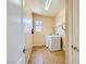 The laundry room has tile floors, a window and modern machines, making laundry chores easier at 1178 Yellow Orchid St, Henderson, NV 89002