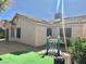 Charming backyard space featuring durable turf, desert landscaping, and covered patio access on a single-story home at 1461 Harmony Hill Dr, Henderson, NV 89014