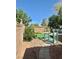 Backyard showcasing a privacy wall and green landscaping at 1461 Harmony Hill Dr, Henderson, NV 89014