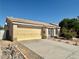 Home exterior showing attached two-car garage, desert landscaping, privacy gate, and quaint brick-paver walkway at 1461 Harmony Hill Dr, Henderson, NV 89014