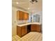 Kitchen featuring white countertops, light wood cabinetry and tiled floors at 1461 Harmony Hill Dr, Henderson, NV 89014