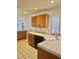Bright kitchen features wooden cabinets, white tile countertops, and a stainless steel sink at 1461 Harmony Hill Dr, Henderson, NV 89014