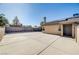 Spacious backyard showcasing a large concrete area with a chimney, solar panels, and brick perimeter at 1708 Anzio St, Las Vegas, NV 89108