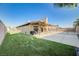 Large backyard with a covered patio area, a grill, and low-maintenance artificial grass at 1708 Anzio St, Las Vegas, NV 89108