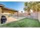This spacious yard includes a covered patio, a grill, and a small patch of artificial turf at 1708 Anzio St, Las Vegas, NV 89108