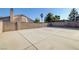 Expansive backyard with a concrete area, block fencing, and palm trees at 1708 Anzio St, Las Vegas, NV 89108