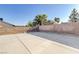 Picturesque backyard featuring a concrete area, block fence, and lush trees at 1708 Anzio St, Las Vegas, NV 89108