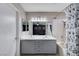 Bathroom with dual sinks, a shower-tub combination, and a mirrored vanity at 1708 Anzio St, Las Vegas, NV 89108