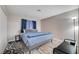 Bedroom with a gray bed, blue bedding, bedside table, and a large window at 1708 Anzio St, Las Vegas, NV 89108