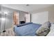 Bedroom with a blue bed, bedside lamp, closet and wood look floors at 1708 Anzio St, Las Vegas, NV 89108