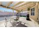 Outdoor dining area under a covered patio with lights and a fan at 1708 Anzio St, Las Vegas, NV 89108